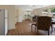 Kitchenette with white cabinets and bar in a living area with hardwood floors at 299 Saint Marys Nw Ln, Marietta, GA 30064