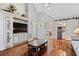 Living room showcasing hardwood floors, built-in cabinetry with a TV, and a nearby coffee bar at 299 Saint Marys Nw Ln, Marietta, GA 30064