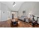 Living room featuring hardwood floors, a vaulted ceiling, and a convenient coffee bar with sliding barn door at 299 Saint Marys Nw Ln, Marietta, GA 30064