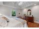 Bright bedroom featuring hardwood floors, a chandelier, and a cozy reading nook with a leather recliner at 299 Saint Marys Nw Ln, Marietta, GA 30064