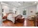 Bedroom with hardwood floors, natural light, a wooden sleigh bed, and an elegant chandelier at 299 Saint Marys Nw Ln, Marietta, GA 30064