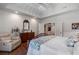 Bedroom featuring hardwood floors, an elegant chandelier, and access to an adjacent living room at 299 Saint Marys Nw Ln, Marietta, GA 30064