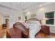 Bedroom with hardwood floors, natural light, and access to a coffee bar with a sliding barn door at 299 Saint Marys Nw Ln, Marietta, GA 30064