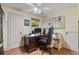 Well-lit home office features a ceiling fan, storage shelving, and a large desk at 299 Saint Marys Nw Ln, Marietta, GA 30064