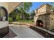 Inviting outdoor stone fireplace and a manicured garden offer a tranquil setting at 299 Saint Marys Nw Ln, Marietta, GA 30064
