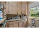 Well-organized pantry with ample shelving, storage cabinets, granite countertops, and a window for natural light at 299 Saint Marys Nw Ln, Marietta, GA 30064