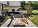 Stone pathway leading to the house from the garden with a stone fireplace on the patio at 299 Saint Marys Nw Ln, Marietta, GA 30064