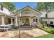 Covered outdoor living space featuring neutral-toned furniture and flagstone patio at 299 Saint Marys Nw Ln, Marietta, GA 30064