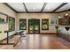 The Personal Cave features exposed beam ceiling, wood floors, bar with natural light, and workout equipment at 299 Saint Marys Nw Ln, Marietta, GA 30064