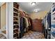Walk-in closet featuring custom shelving, a dresser, and ample storage for shoes and clothing at 299 Saint Marys Nw Ln, Marietta, GA 30064
