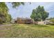 A large backyard featuring the home, an ornate deck, and plenty of mature trees at 1766 Scholar Dr, Lawrenceville, GA 30044