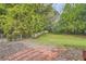 Backyard featuring mature trees, landscaping, and fenced in area at 1766 Scholar Dr, Lawrenceville, GA 30044