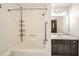 A bright bathroom featuring a bathtub and a dark vanity at 1766 Scholar Dr, Lawrenceville, GA 30044