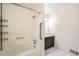 Bathroom featuring a bathtub with shower head, a vanity, and white and grey flooring at 1766 Scholar Dr, Lawrenceville, GA 30044