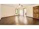 Spacious bedroom with dark laminate flooring, ceiling fan, and a view into the bathroom at 1766 Scholar Dr, Lawrenceville, GA 30044