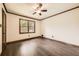 Bedroom featuring dark laminate flooring, one window, and a ceiling fan at 1766 Scholar Dr, Lawrenceville, GA 30044