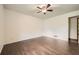 Bedroom with hardwood flooring, ceiling fan, and neutral paint at 1766 Scholar Dr, Lawrenceville, GA 30044