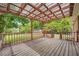 Large wooden deck with roof covering, with an ornate railing at 1766 Scholar Dr, Lawrenceville, GA 30044