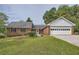 Charming brick ranch home with a well-maintained front yard and attached garage at 1766 Scholar Dr, Lawrenceville, GA 30044