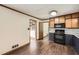 Traditional style kitchen with black appliances and hardwood flooring at 1766 Scholar Dr, Lawrenceville, GA 30044
