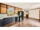 Well-lit kitchen boasts black appliances, light countertops, and wood-style flooring at 1766 Scholar Dr, Lawrenceville, GA 30044