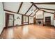 Bright living room features hardwood floors, vaulted ceilings, and brick fireplace at 1766 Scholar Dr, Lawrenceville, GA 30044