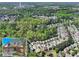 Aerial view of the community with lush green trees, ponds, and multiple houses at 2402 Jasmine Glen Dr, Buford, GA 30519