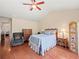 Cozy bedroom with vaulted ceiling, hardwood floors, ceiling fan and sitting area at 2402 Jasmine Glen Dr, Buford, GA 30519
