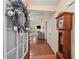Inviting home foyer with gleaming hardwood floors, traditional grandfather clock, and view of living room at 2402 Jasmine Glen Dr, Buford, GA 30519