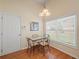 Bright dining area with a glass table, lots of light, and hardwood floors at 2402 Jasmine Glen Dr, Buford, GA 30519