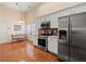 Modern kitchen with stainless appliances, a breakfast nook, and hardwood flooring at 2402 Jasmine Glen Dr, Buford, GA 30519