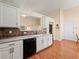 Bright kitchen featuring white cabinets, dark appliances, and an open layout at 2402 Jasmine Glen Dr, Buford, GA 30519