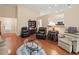 Open living room with hardwood floors, comfortable seating, and seamless flow into the kitchen at 2402 Jasmine Glen Dr, Buford, GA 30519