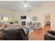 Bright living room features hardwood floors, fireplace, ceiling fan, and large windows overlooking the backyard at 2402 Jasmine Glen Dr, Buford, GA 30519