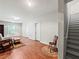 Cozy living room featuring wood flooring, stairs, and neutral color scheme at 2402 Jasmine Glen Dr, Buford, GA 30519