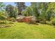Exterior view of backyard showcasing a house with multiple balconies, decks and lush green surroundings at 2645 Davenport Rd, Duluth, GA 30096