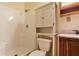 Bathroom with tub and shower featuring a neutral color scheme and built in cabinet at 2645 Davenport Rd, Duluth, GA 30096