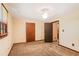 Comfortable bedroom with neutral walls, plush carpet, and ample doorways, offering a cozy living space at 2645 Davenport Rd, Duluth, GA 30096
