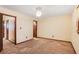 Spacious bedroom with neutral walls, plush carpet, and multiple doorways, offering a comfortable living space at 2645 Davenport Rd, Duluth, GA 30096