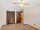 Bedroom featuring neutral walls, carpet flooring, and a closet with folding doors at 2645 Davenport Rd, Duluth, GA 30096