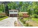 Charming home featuring a two-car garage and a spacious deck, nestled among mature trees at 2645 Davenport Rd, Duluth, GA 30096