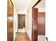 A long hallway with multiple wood-paneled doors and wood-patterned flooring at 2645 Davenport Rd, Duluth, GA 30096