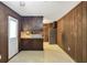 Functional kitchenette with essential appliances and wood-paneled walls at 2645 Davenport Rd, Duluth, GA 30096