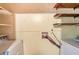 Functional laundry room with washer and dryer hookups and shelving units for organized storage solutions at 2645 Davenport Rd, Duluth, GA 30096