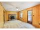 Cozy living room features a brick fireplace, ceiling fan, and door to exterior, offering a comfortable living space at 2645 Davenport Rd, Duluth, GA 30096