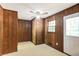 Wood paneled mud room with a window, linoleum flooring, and a ceiling fan at 2645 Davenport Rd, Duluth, GA 30096