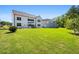 Expansive backyard featuring a lush lawn, patio with seating, and a two-story white home at 4188 Fawn Ivy Ln, Marietta, GA 30064