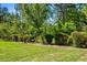 Lush backyard featuring a bird bath and mature landscaping with greenery and bushes at 4188 Fawn Ivy Ln, Marietta, GA 30064