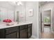 Bathroom with a modern sink, dark vanity, and view to bedroom at 4188 Fawn Ivy Ln, Marietta, GA 30064