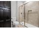 Bathroom featuring a toilet, modern shower with glass doors, and spacious storage cabinets at 4188 Fawn Ivy Ln, Marietta, GA 30064